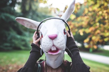 Rabbit mask woman listening to music clipart