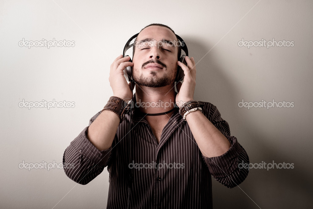 young stylish man listening to music