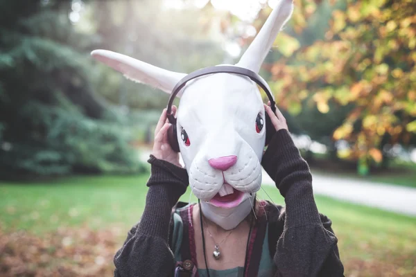 Rabbit mask woman listening to music — Stock Photo, Image