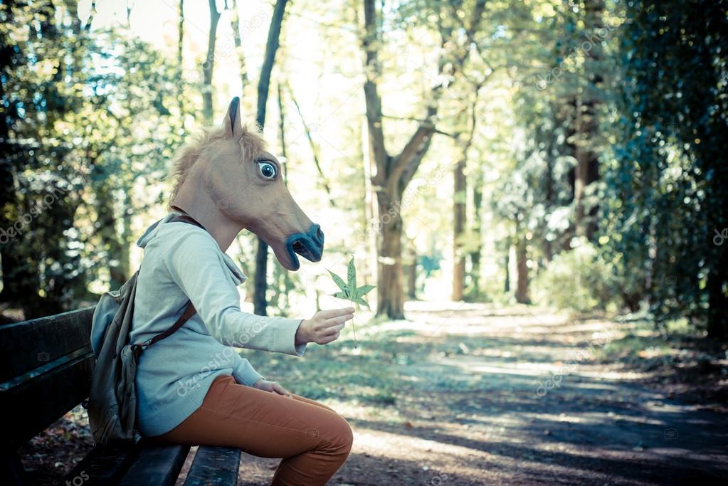 young hipster horse mask woman in autumn