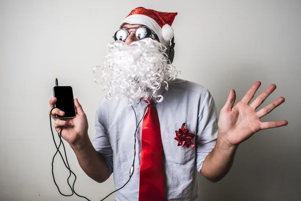 Funny santa claus babbo natale listening music — Stock Photo, Image