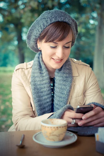 Young beautiful woman sitting at the bar — Stock Photo, Image