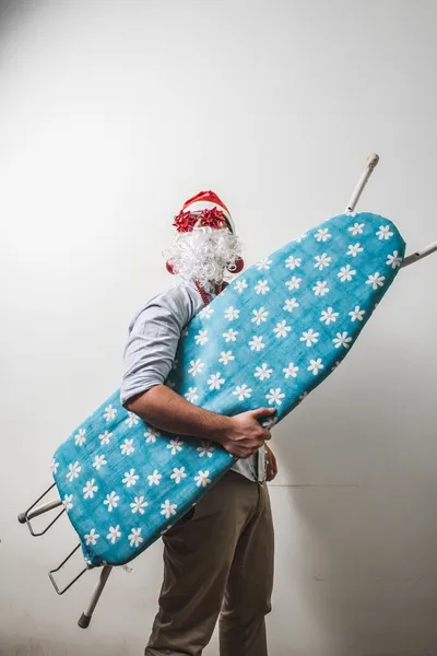 Funny santa claus babbo natale ironing surfer — Stock Photo, Image