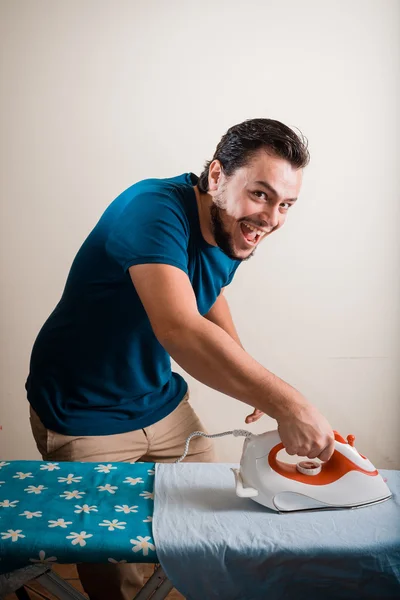 Young stylish man housewife ironing — Stock Photo, Image