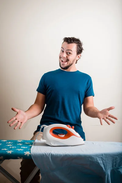 Young stylish man housewife ironing — Stock Photo, Image