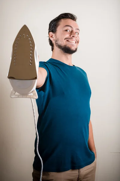 Young stylish man housewife ironing — Stock Photo, Image