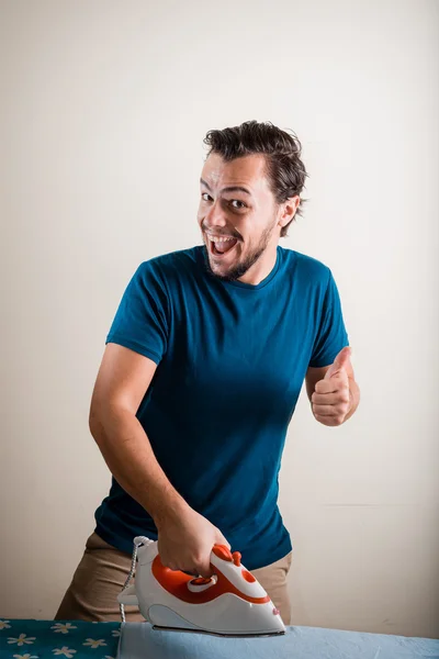 Young stylish man housewife ironing — Stock Photo, Image