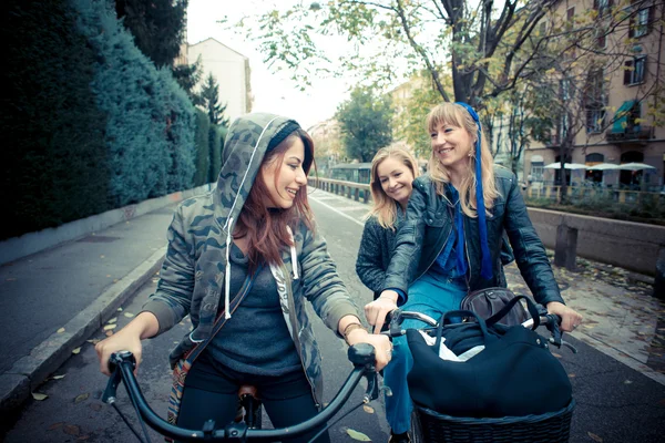 Three friends woman on bike — Stock Photo, Image