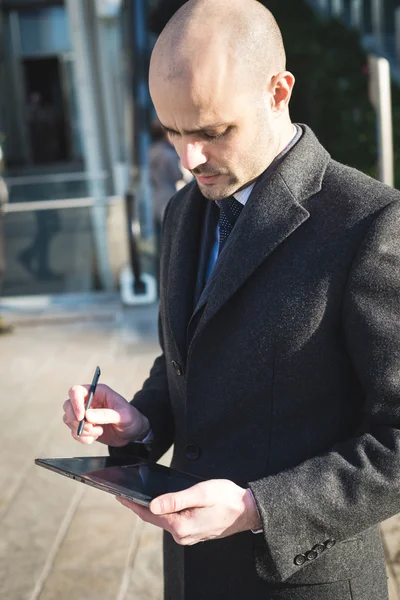 Successful elegant fashionable businessman using tablet — Stock Photo, Image