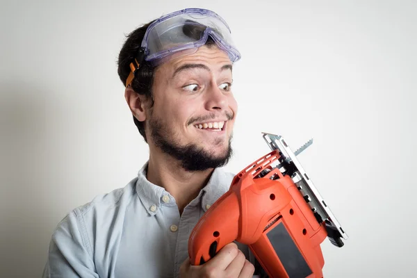 Jeune homme bricolage de travail avec scie électrique — Photo