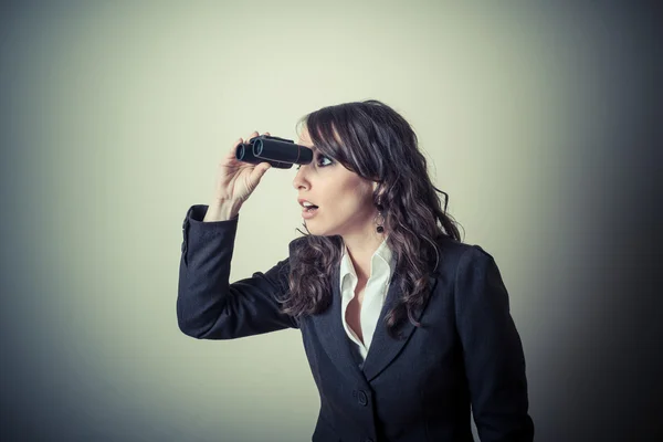 Beautiful young businesswoman with binocular — Stock Photo, Image