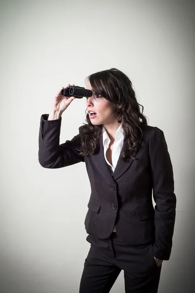 Beautiful young businesswoman with binocular — Stock Photo, Image