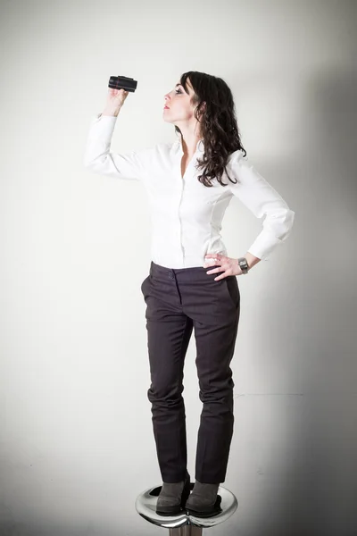 Beautiful young businesswoman with binocular — Stock Photo, Image