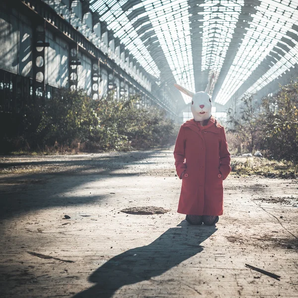 Rabbit mask woman red coat — Stock Photo, Image