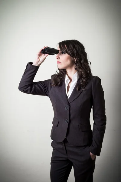 Beautiful young businesswoman with binocular — Stock Photo, Image