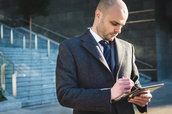 Successful elegant fashionable businessman using tablet — Stock Photo, Image