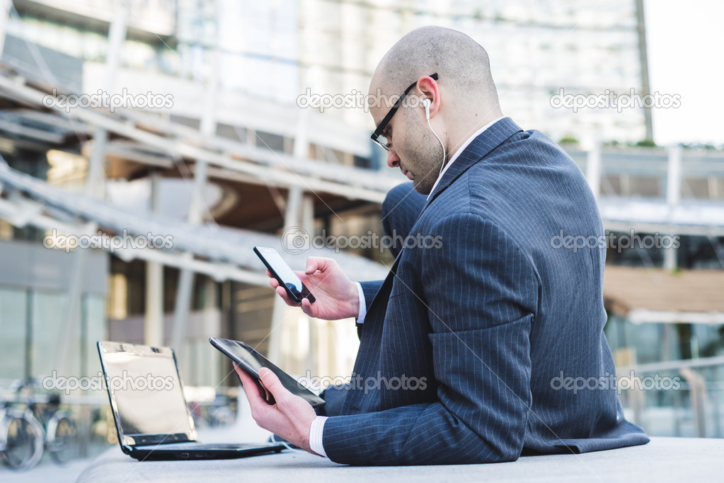 successful elegant fashionable businessman using tablet