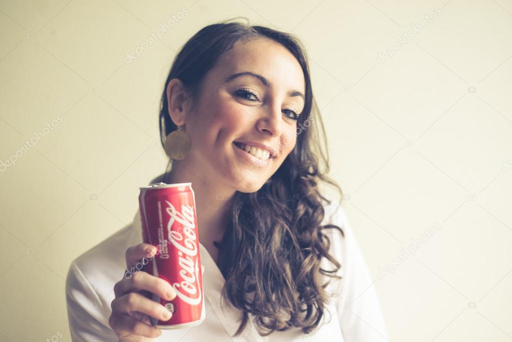 Beautiful woman drinking coca cola can 33 cl Stock Editorial Photo