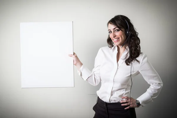 Beautiful young businesswoman holding white board — Stock Photo, Image