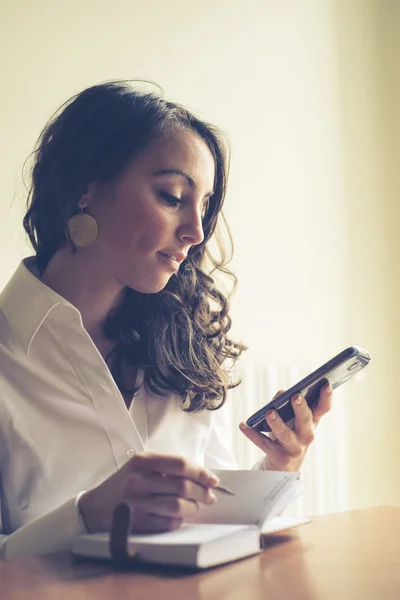 Hermosa mujer en casa escribiendo y trabajando — Foto de Stock