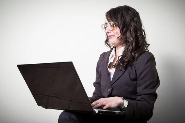 Beautiful young businesswoman using notebook — Stock Photo, Image