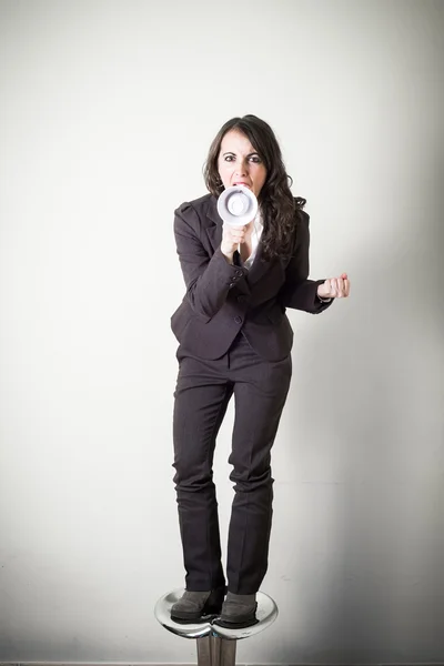 Beautiful young businesswoman with little megaphone — Stock Photo, Image