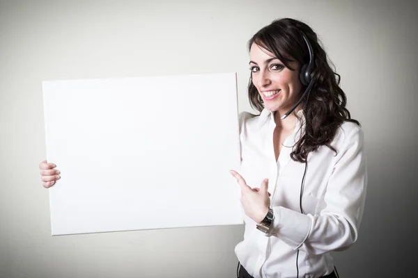 Beautiful young businesswoman holding white board — Stock Photo, Image