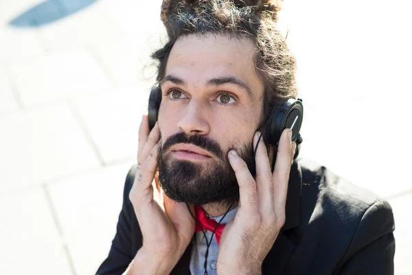 Stylish elegant dreadlocks businessman listening to music — Stock Photo, Image