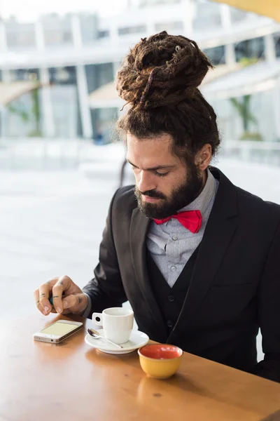 Stylish elegant dreadlocks businessman at the bar — Stock Photo, Image