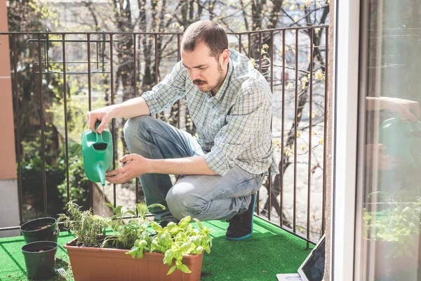 Handsome stylish man gardening and watering — Stock Photo, Image