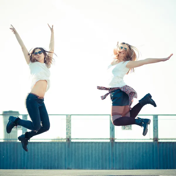 Two beautiful women jumping — Stock Photo, Image