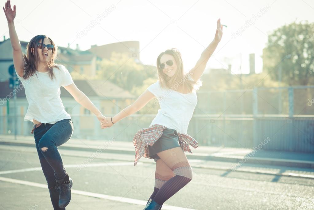 Two beautiful women jumping