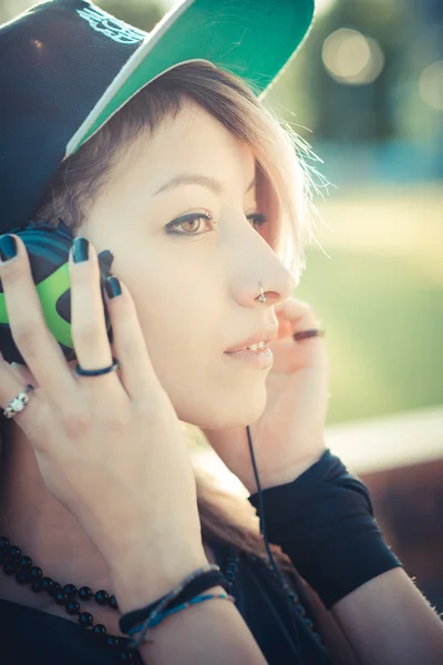 Young beautiful model woman listening music — Stock Photo, Image