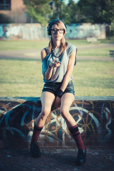 Young beautiful model woman listening music — Stock Photo, Image