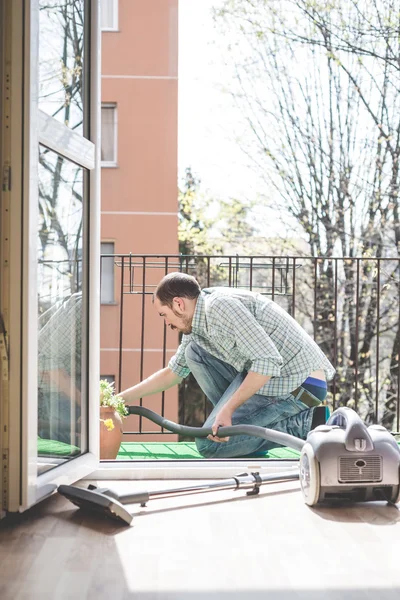 Handsome stylish man using hoover — Stock Photo, Image