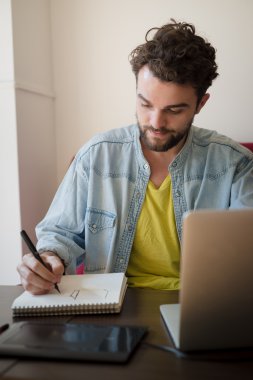 yakışıklı hipster modern insanın çalışma ev dizüstü kullanarak