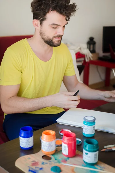 Handsome hipster modern man painting — Stock Photo, Image