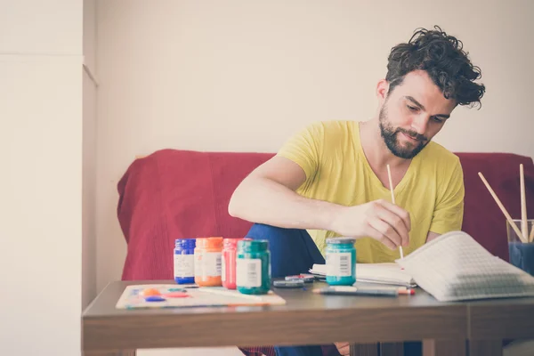 Handsome hipster modern man painting — Stock Photo, Image