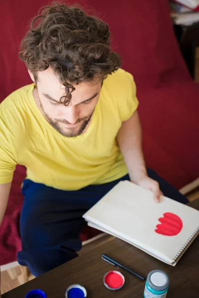 Handsome hipster modern man painting — Stock Photo, Image