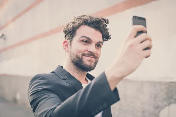 Handsome hipster modern man using smart phone selfie — Stock Photo, Image
