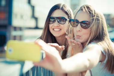 selfie iki güzel genç kadın akıllı kullanarak telefon
