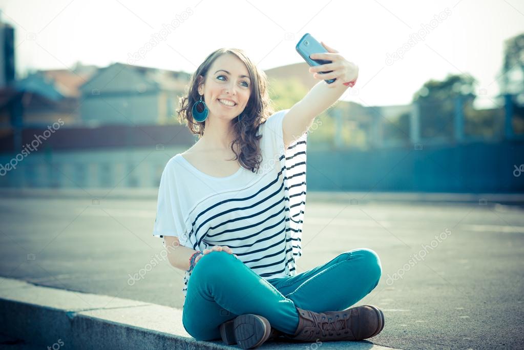 young beautiful brunette woman selfie with smart phone