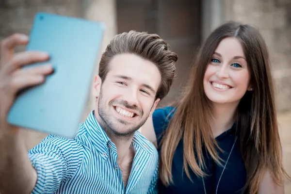 Young beautiful couple lovers using tablet — Stock Photo, Image