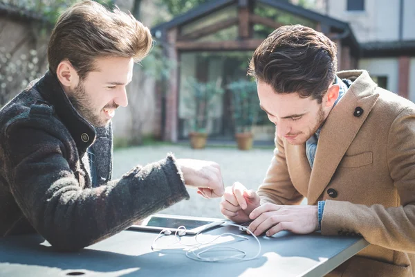 Two young handsome fashion model businessmen using tablet — Stock Photo, Image