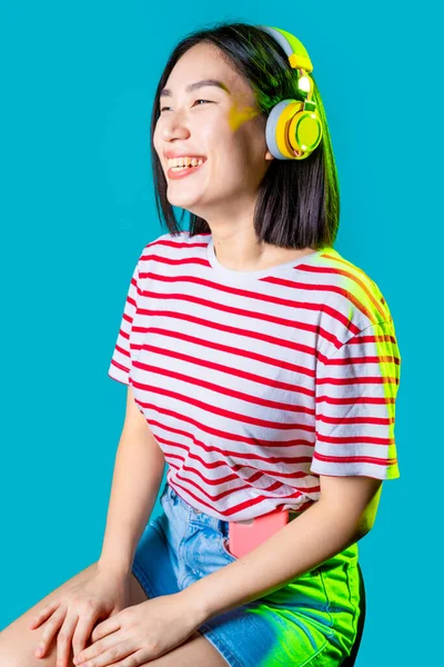 Young Asiatic Woman Wearing Wireless Bluetooth Headphones Listening Music Laughing — Stock Photo, Image