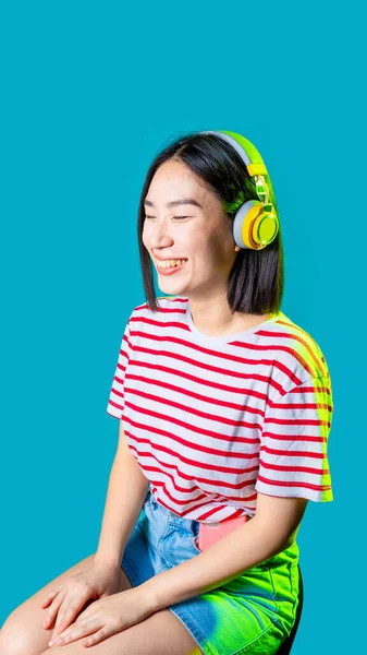 Genç Asyalı Kadın Kablosuz Kulaklık Takıyor Gülüşmeler Dinliyor Dikey Telif — Stok fotoğraf