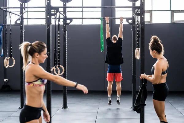 Man and women training work out together indoors gym