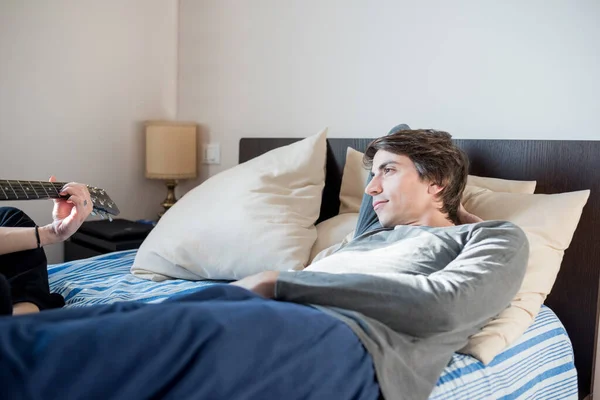 Young Man Wearing Pajama Lying Bed Indoors Relaxing Listening Music — Stock Photo, Image