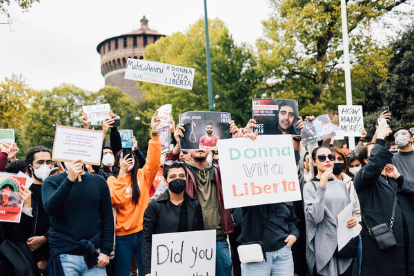 MILAN, ITALY - SEPTEMBER 25, 2022: Protestors demonstrating at Castello Sforzesco in Milan, Italy, following the death of Mahsa Amini. 