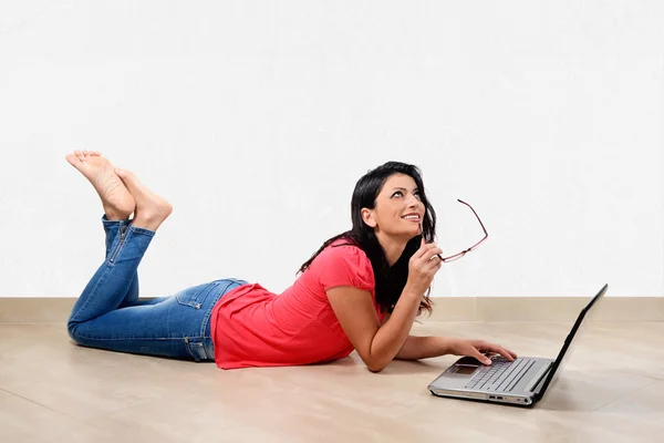 Young woman smiling in front of laptop — Stock Photo, Image